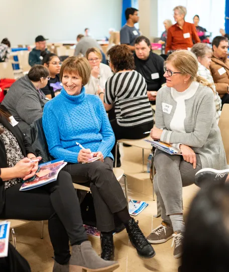 People sitting in discussion at 2023 Rebuilding HOPE Conference in Sydney, NS.