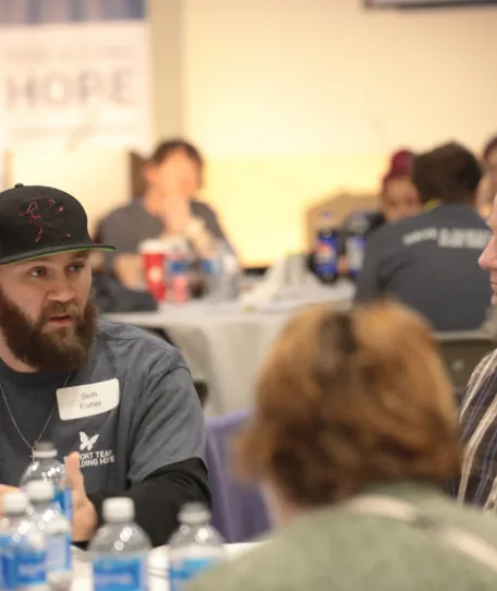 People sitting around a table at the Rebuilding HOPE Conference in March