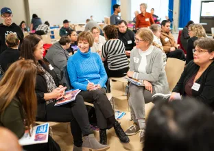 People sitting in discussion at 2023 Rebuilding HOPE Conference in Sydney, NS.