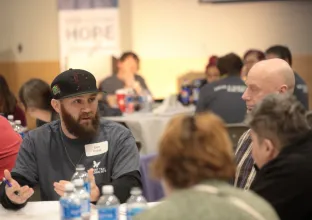 People sitting around a table at the Rebuilding HOPE Conference in March
